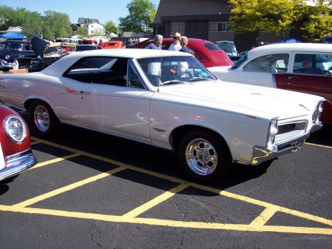 1972 Ford Ranchero - A white 1965 Pontiac Grand Prix coupe is parked at an outdoor event.