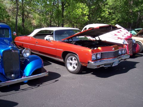 1972 Ford Ranchero - An orange convertible, likely a 1971 model, is displayed with its hood open at an outdoor car show.