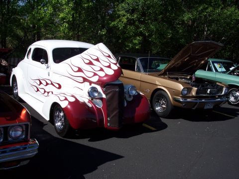 1972 Ford Ranchero - Multiple vehicles displayed at an outdoor car show, including a custom hot rod and a classic Ford Mustang.