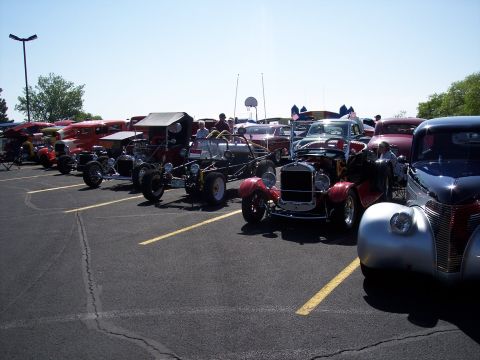 1972 Ford Ranchero - A variety of custom and classic cars are lined up in a parking lot, likely at a car show.