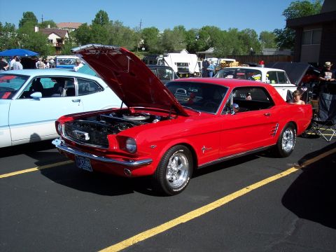1972 Ford Ranchero - A classic red Mustang is displayed with its hood up at an outdoor event.