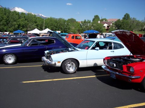1972 Ford Ranchero - A light blue and white 1972 Ford Ranchero is displayed with its hood open at a car show.