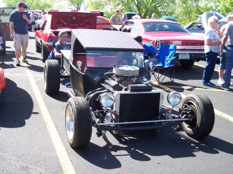 1972 Ford Ranchero - A custom hot rod with a prominent engine and unique checkered roof is on display at an outdoor car event.