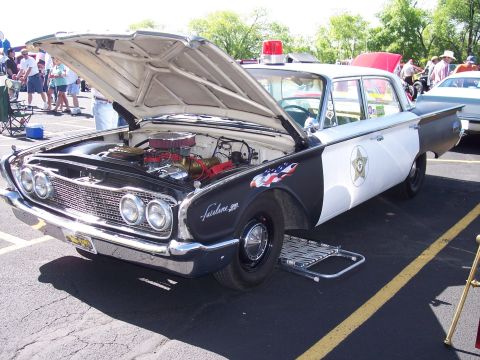 1972 Ford Ranchero - This police car, likely from the early 1960s, has its hood open, revealing the engine compartment.
