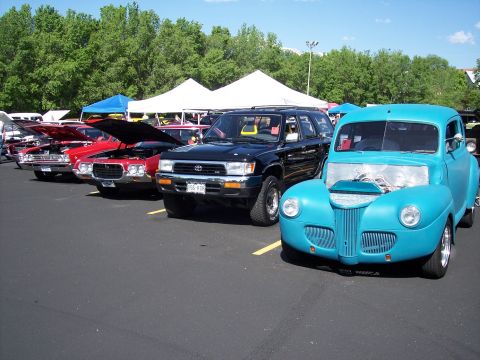 1972 Ford Ranchero - Cars on display at an outdoor event, with tents and trees in the background.