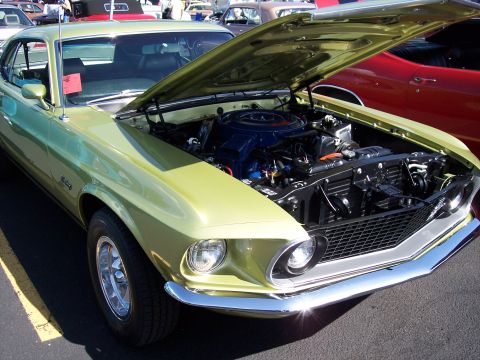 1972 Ford Ranchero - A classic Ford Mustang is displayed with its hood open, revealing the engine bay.