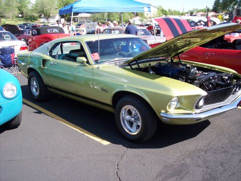 1972 Ford Ranchero - A lime green 1969 Ford Mustang Mach 1 is displayed with its hood open at a car show.