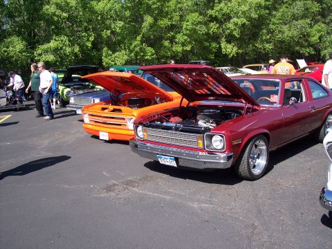 1972 Ford Ranchero - Several classic vehicles are on display with their hoods up at an outdoor event.