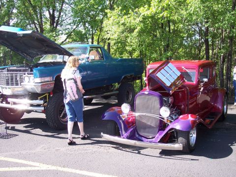 1972 Ford Ranchero - Two custom vehicles are displayed at an outdoor event with trees in the background.