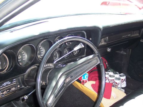 1972 Ford Ranchero - The interior of a 1972 Ford Ranchero shows a black dashboard, steering wheel, and several cans of Dr. Pepper on the floor.