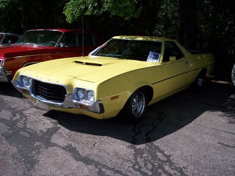 1972 Ford Ranchero - A yellow 1972 Ford Ranchero is parked outdoors next to a red vehicle.