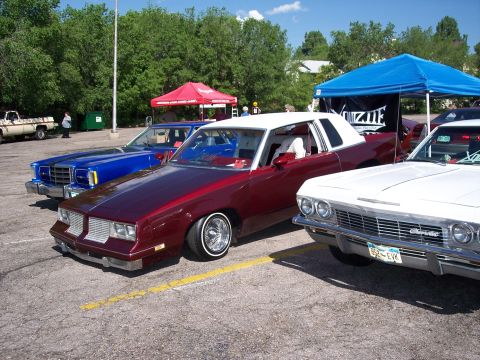 1972 Ford Ranchero - Maroon 1977 Oldsmobile Cutlass Supreme coupe with white vinyl top and chrome wheels.