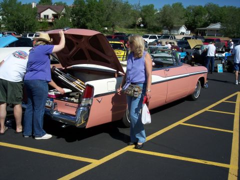 1972 Ford Ranchero - A pink and white convertible is parked at an outdoor event, with its trunk open and golf clubs visible.