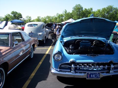 1972 Ford Ranchero - A blue 1951 car is displayed with its hood open, revealing the engine, at an outdoor car show.
