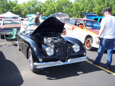 1972 Ford Ranchero - Black convertible at a car show, hood is open to display the engine.