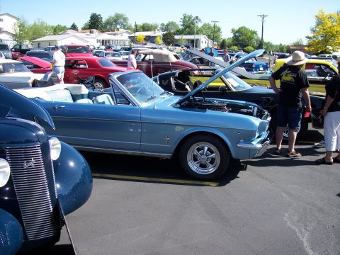 1972 Ford Ranchero - A light blue 1965 Ford Mustang convertible is displayed at an outdoor event with its hood open.