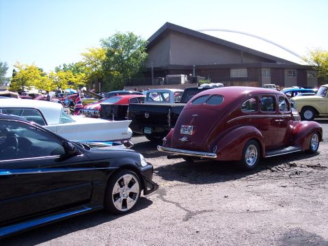 1972 Ford Ranchero - A collection of vehicles, including a maroon sedan from the late 1930s, are gathered outdoors.