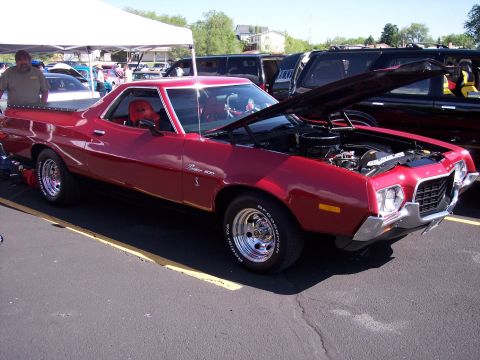 1972 Ford Ranchero - Red 1972 Ford Ranchero 500 parked at an outdoor event, hood up to display the engine.