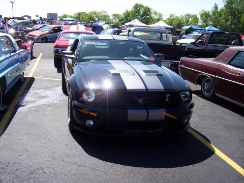 1972 Ford Ranchero - A modern Ford Mustang Shelby GT500 is parked at a car show, surrounded by other vehicles.