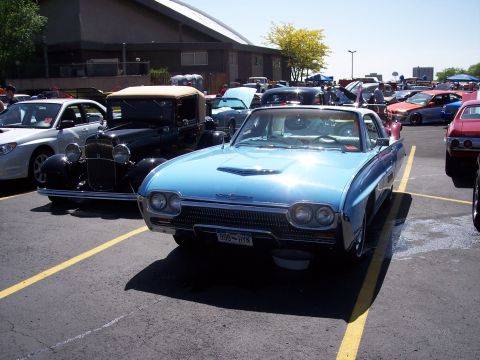 1972 Ford Ranchero - A light blue 1966 Ford Thunderbird is parked at an outdoor event, with other classic cars visible.