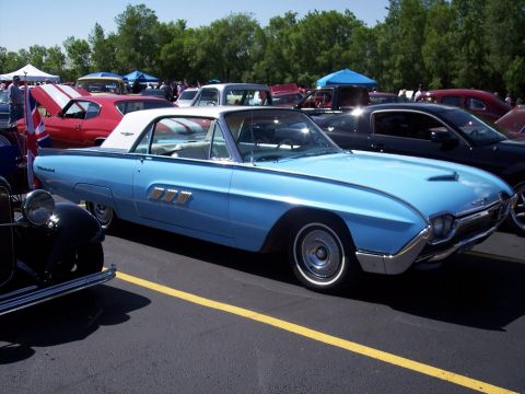 1972 Ford Ranchero - A light blue 1961 Ford Thunderbird is parked at a car show with other cars in the background.