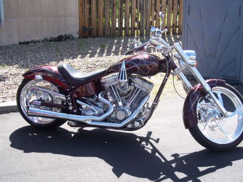 1972 Ford Ranchero - Custom chopper motorcycle parked outdoors with a wooden fence in the background.