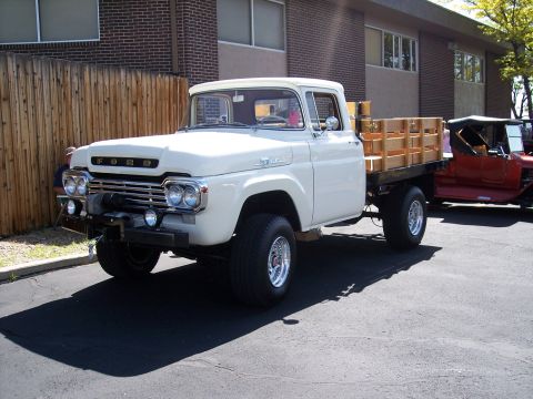 1972 Ford Ranchero - A white 1959 Ford pickup truck is parked next to a red vintage vehicle.