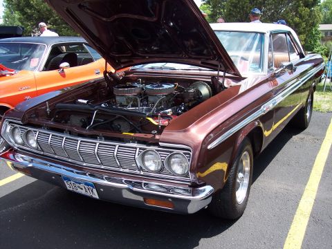 1972 Ford Ranchero - This brown 1964 Plymouth Barracuda features a V8 engine with dual carburetors and a white roof.