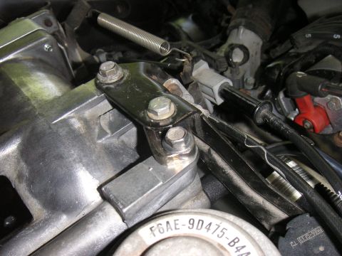 1996 Ford Crown Victoria - Close-up of throttle body linkage and spring assembly, with part number visible.