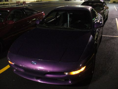 1991 Ford Probe - A purple 1993 Ford Probe is parked in a lot at night, with another car visible behind it.