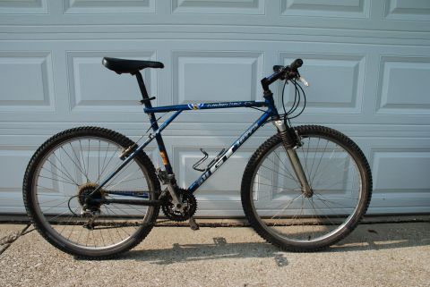 1997 Ford Probe - A blue GT mountain bike is shown parked in front of a white garage door.