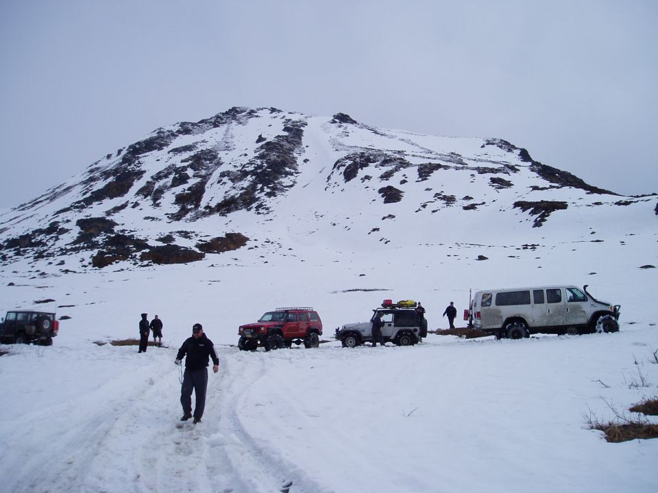 White Ford E350 van in snow, side view. 2000
