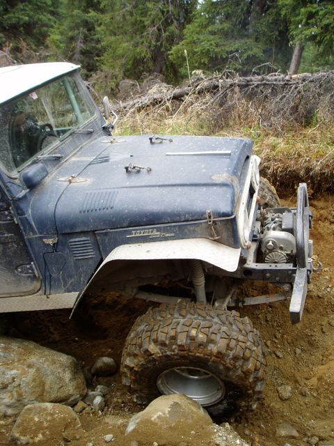 2000 Ford E350 - Toyota Land Cruiser FJ40 navigating difficult terrain with large tires.