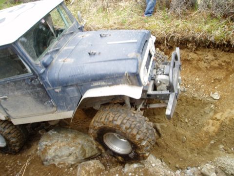 2000 Ford E350 - This off-road vehicle is navigating a difficult, rocky terrain.