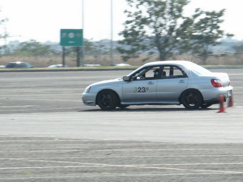 2001 Mercury Grand Marquis - Silver sedan with racing number 23u on the door navigates a course marked by orange cones.