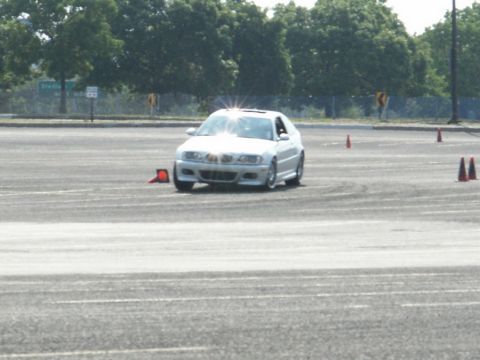 2001 Mercury Grand Marquis - A white sedan is seen from the front on a paved lot with traffic cones.