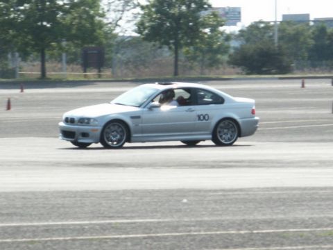 2001 Mercury Grand Marquis - Silver BMW M3 coupe with number 100 on door, participating in a track event.