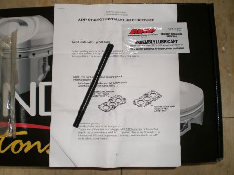 1995 Ford Probe - An ARP Stud Kit installation procedure sheet showing left and right head gasket diagrams, laid on a piston box with a single black head stu…