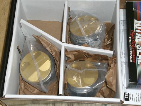 1995 Ford Probe - A set of four performance pistons and a box of piston rings are packaged in a white cardboard box.