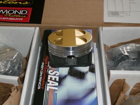 1995 Ford Probe - Performance pistons are shown in their packaging, alongside other components.