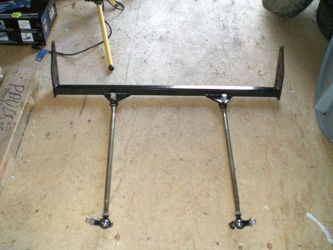 1995 Ford Probe - A black powder-coated tubular suspension crossmember or anti-roll bar assembly with bolt-on end brackets, fitted with two long adjustable h…