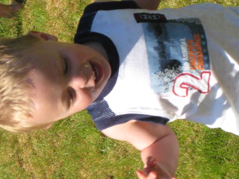 2000 Ford E350 - Child with a graphic t-shirt smiles while lying on the grass.