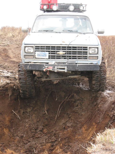 2000 Ford E350 - This van is attempting to navigate a steep, muddy ditch, its off-road capabilities.
