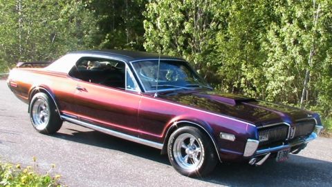 1968 Mercury Cougar - This 1968 Mercury Cougar features a striking metallic purple paint job and a contrasting black vinyl roof.