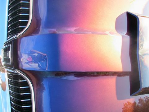 1968 Mercury Cougar - Close-up of a 1968 Mercury Cougar's hood a custom color-shift paint job and its distinctive grille.