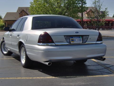 2002 Ford Crown Victoria - Rear view of a silver 2002 Ford Crown Victoria, tinted taillights and chrome exhaust tips.