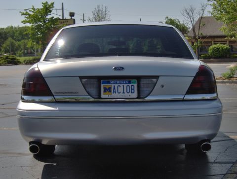 2002 Ford Crown Victoria - Rear view of a silver 2002 Ford Crown Victoria, a Michigan license plate and dual exhaust pipes.