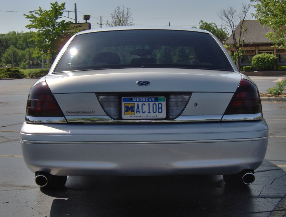 Silver 2002 Ford Crown Victoria rear view with Michigan license plate