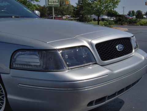 2002 Ford Crown Victoria - Front view of a silver 2002 Ford Crown Victoria showing the grille and headlights.
