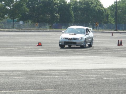 2001 Mercury Grand Marquis - Silver Subaru Impreza WRX STI navigates a course marked by traffic cones.